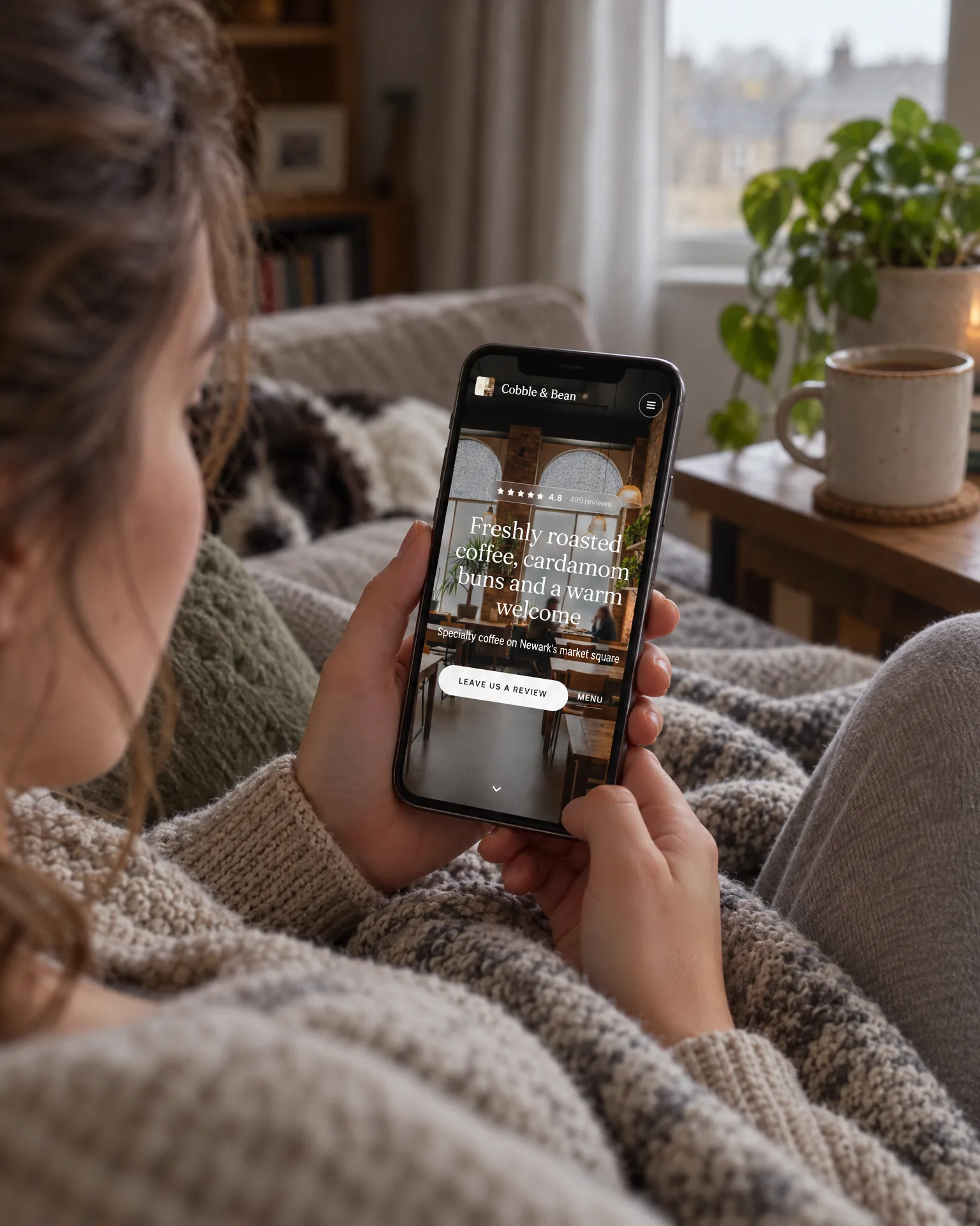 Someone browsing the Cobble & Bean website on their phone at home